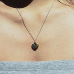 fragile heart necklace with green heart moissanite.
