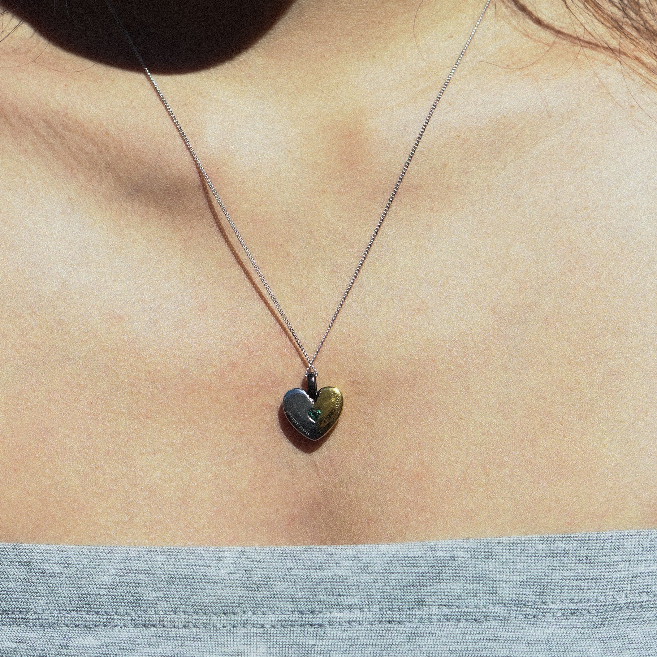 fragile heart necklace with green heart moissanite.